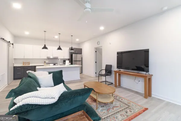 a living room with furniture and a flat screen tv