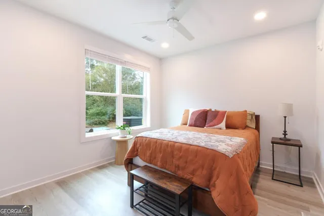 a bed sitting in a bedroom next to a window