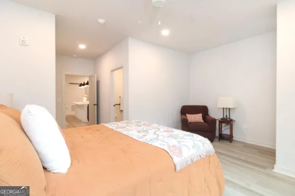 a bedroom with a bed and a chair
