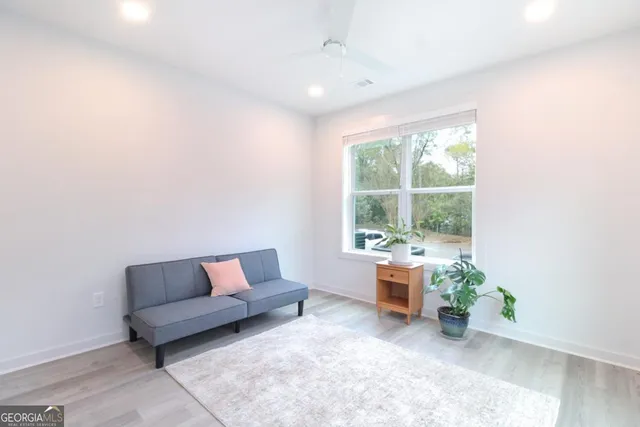 a living room with furniture and floor to ceiling window