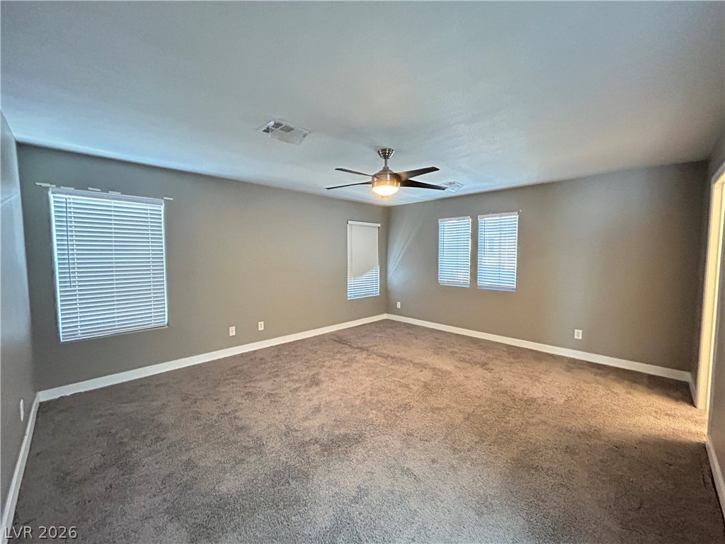 6538 Elm Spring Las Vegas, NV 89148 - Photo 7 of 29 A spacious room offers comfortable carpeting and multiple windows for abundant natural light.