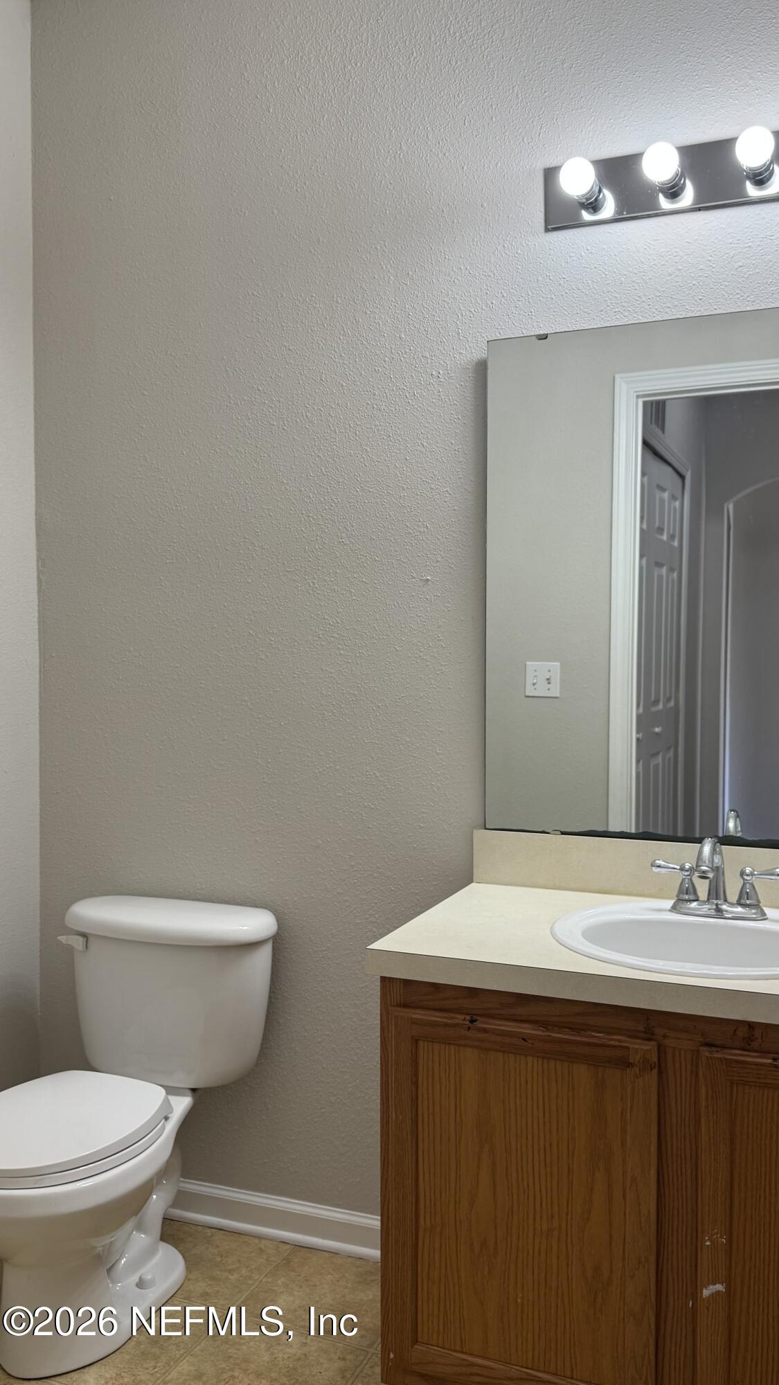 5260 Collins Road, Unit 1504 Jacksonville, FL 32244 - Photo 7 of 12 a bathroom with a sink and a toilet