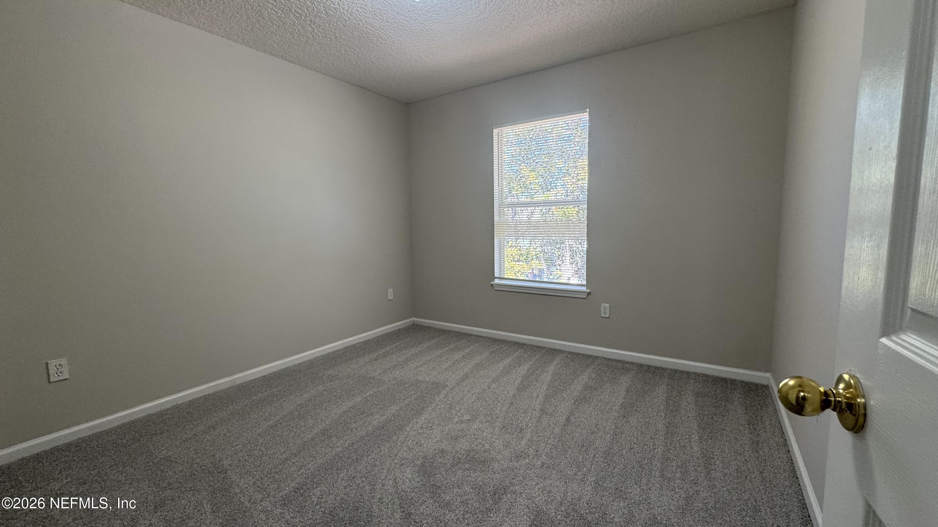 5260 Collins Road, Unit 1504 Jacksonville, FL 32244 - Photo 9 of 12 an empty room with a window