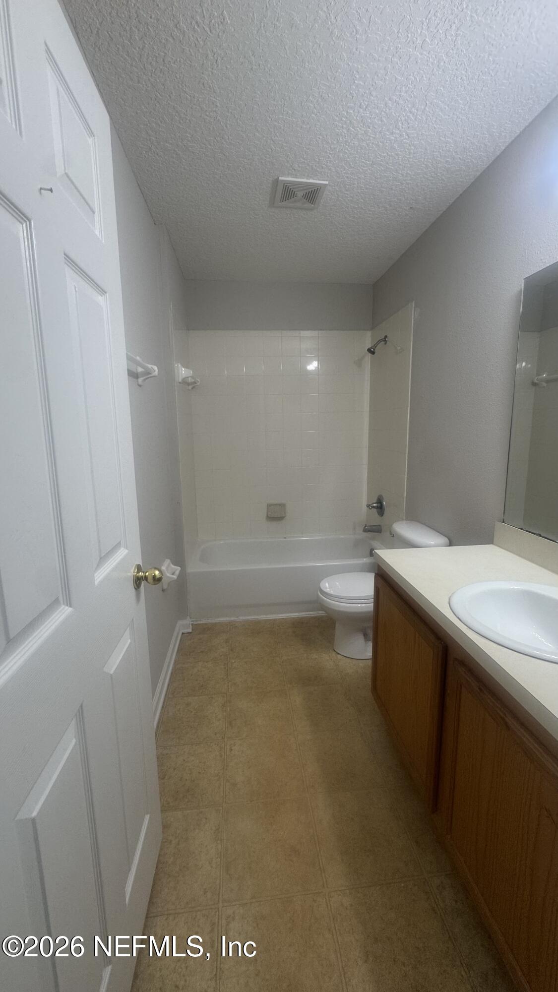 5260 Collins Road, Unit 1504 Jacksonville, FL 32244 - Photo 10 of 12 a bathroom with a sink a toilet and shower