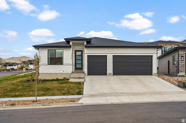 3349 Oxford Loop Morgan, UT 84050 - Photo 37 of 47 Prairie-style house featuring a garage, concrete driveway, a front yard, a mountain view, and roof with shingles