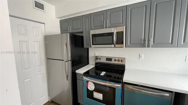 a kitchen with cabinets and stainless steel appliances