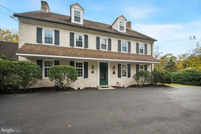 a front view of a house with a garden and porch