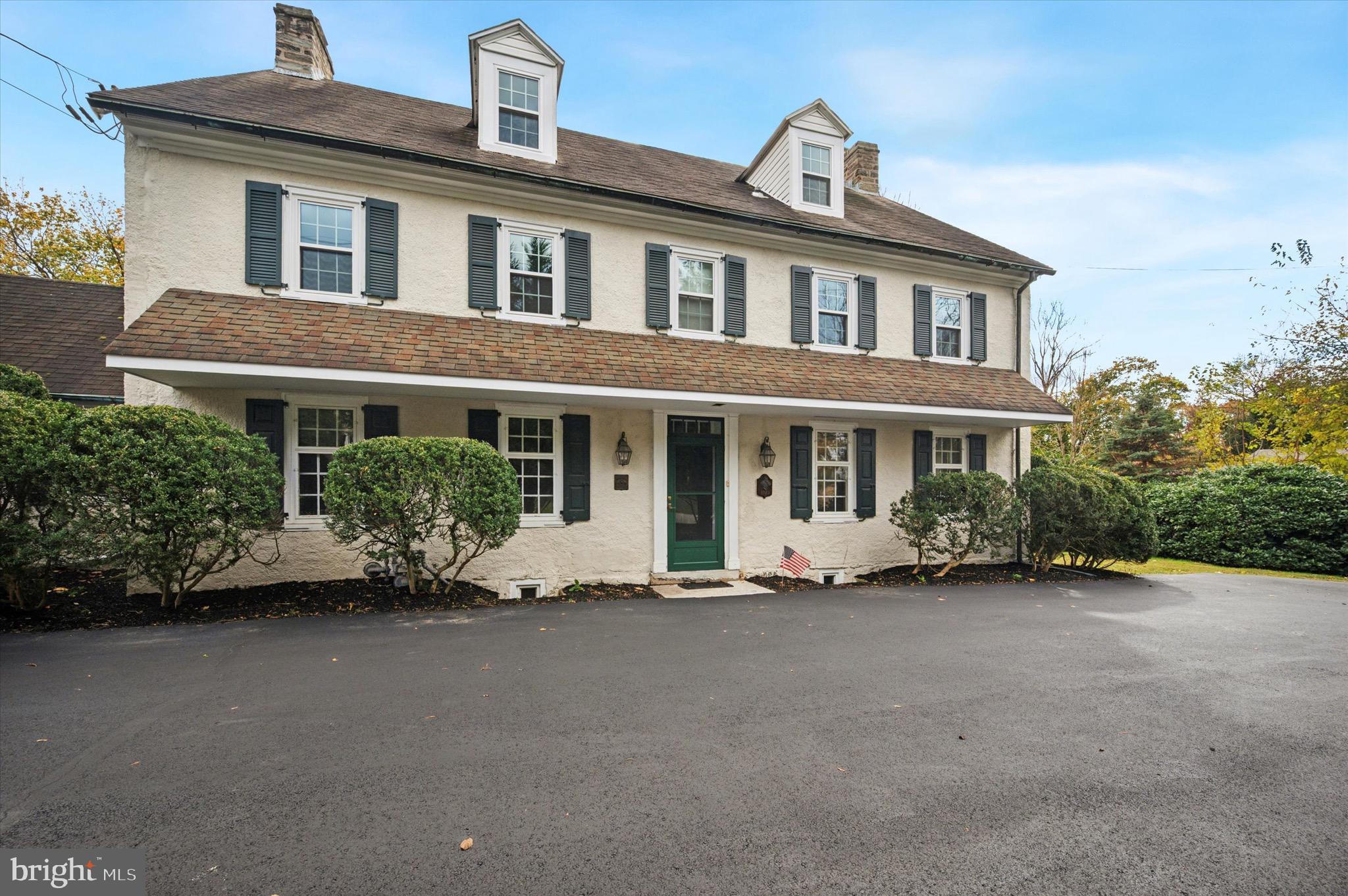 a front view of a house with a garden and porch