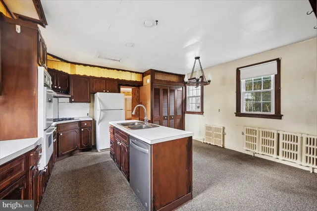 a view of kitchen center island sink stove and oven