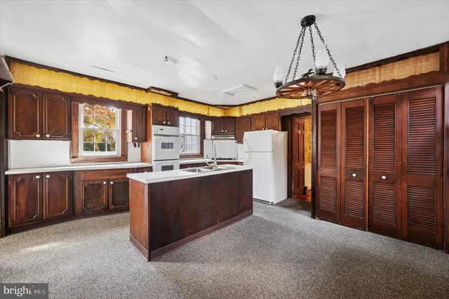 a kitchen with stainless steel appliances granite countertop a sink and cabinets