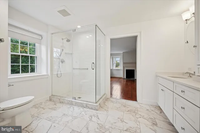 a bathroom with a shower toilet and sink