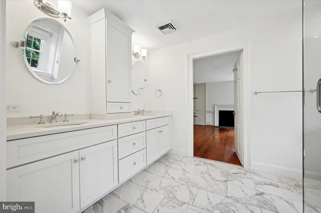 a spacious bathroom with a double vanity sink and a mirror