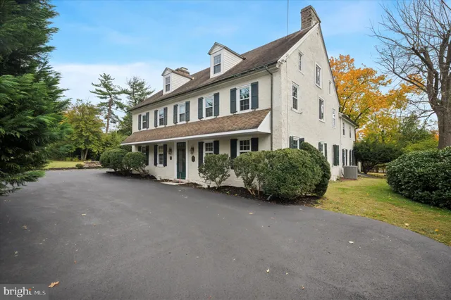 a view of a house with a yard and potted plants