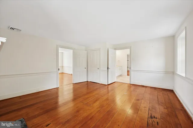 an empty room with wooden floor