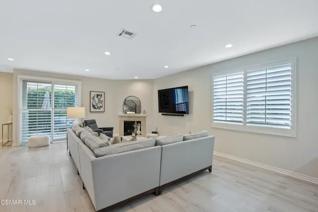 a living room with furniture tv and a window