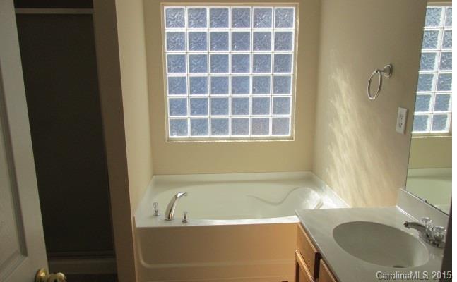 8808 Chalkstone Road Charlotte, NC 28216 - Photo 11 of 14 a bath tub sitting next to a blue sink
