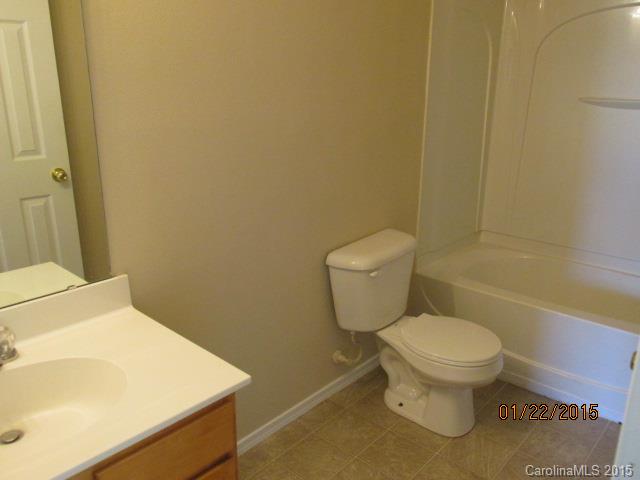 8808 Chalkstone Road Charlotte, NC 28216 - Photo 14 of 14 a white toilet sitting next to a bathroom sink
