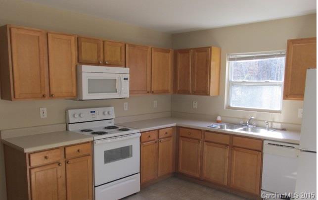 8808 Chalkstone Road Charlotte, NC 28216 - Photo 4 of 14 a kitchen with white cabinets appliances a sink and a window