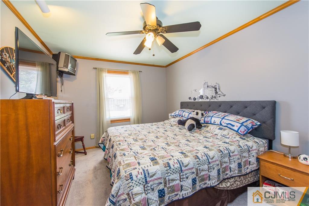 127 Idlewild Road Edison, NJ 08817 - Photo 13 of 21 a bedroom with a bed and a chandelier