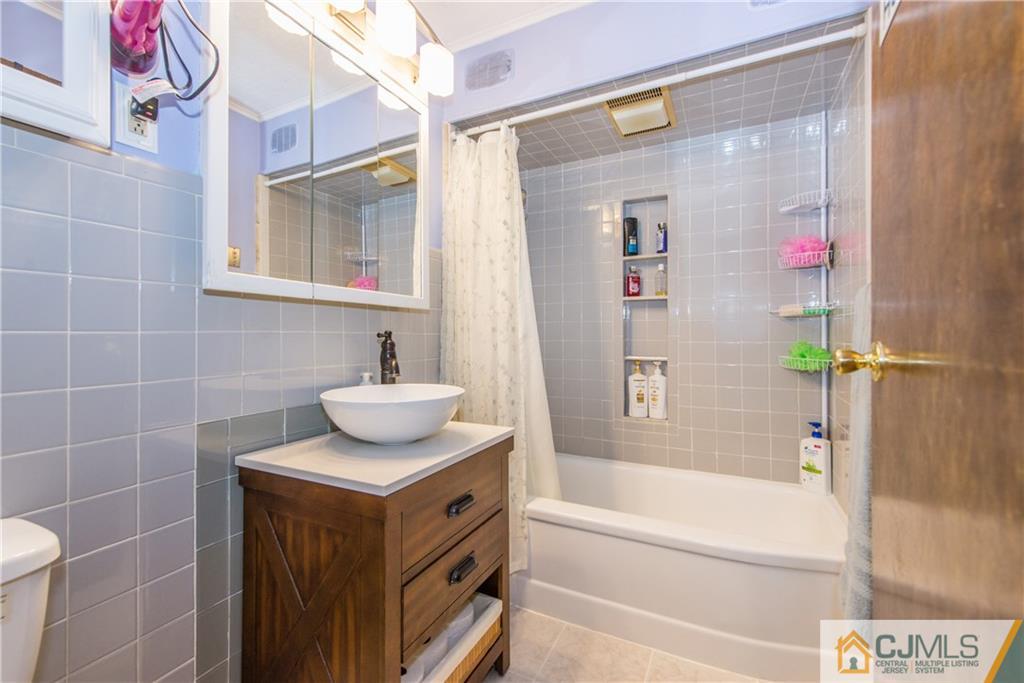 127 Idlewild Road Edison, NJ 08817 - Photo 15 of 21 a bathroom with a sink and a mirror