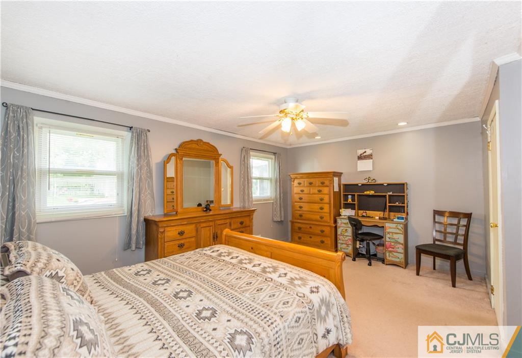 127 Idlewild Road Edison, NJ 08817 - Photo 17 of 21 a bedroom with a bed and dresser with mirror