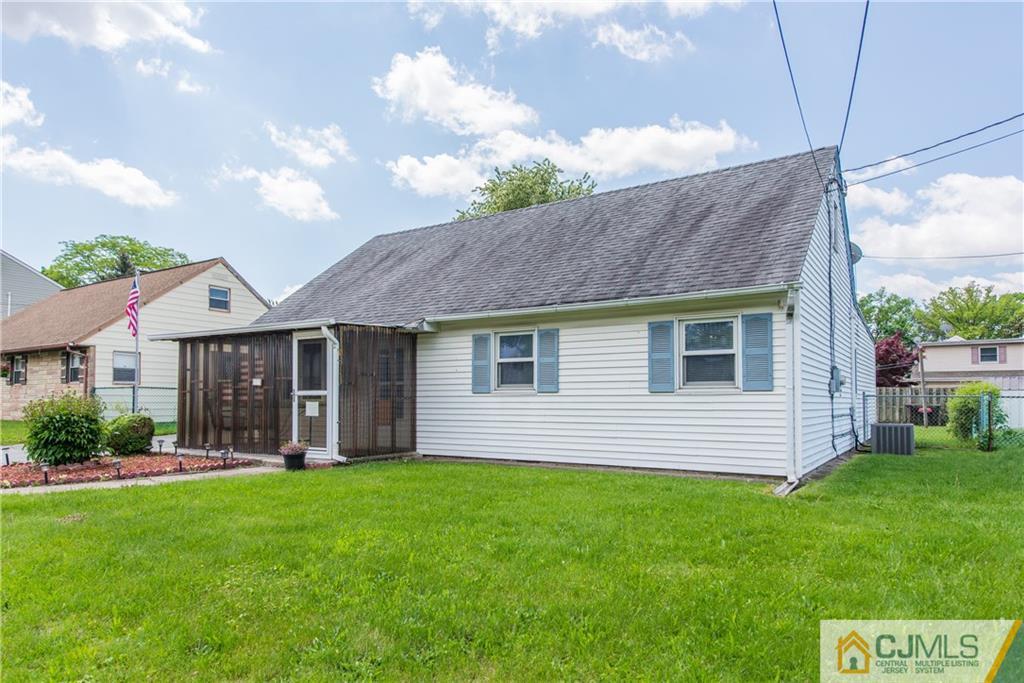 127 Idlewild Road Edison, NJ 08817 - Photo 3 of 21 a view of a house with brick walls and a yard with a large tree