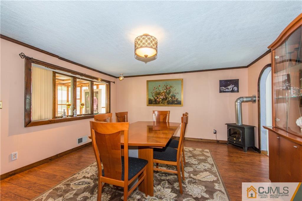 127 Idlewild Road Edison, NJ 08817 - Photo 4 of 21 a view of a dining room with furniture a rug and wooden floor