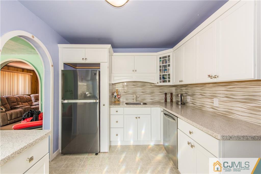 127 Idlewild Road Edison, NJ 08817 - Photo 6 of 21 a kitchen with granite countertop a sink stainless steel appliances and cabinets