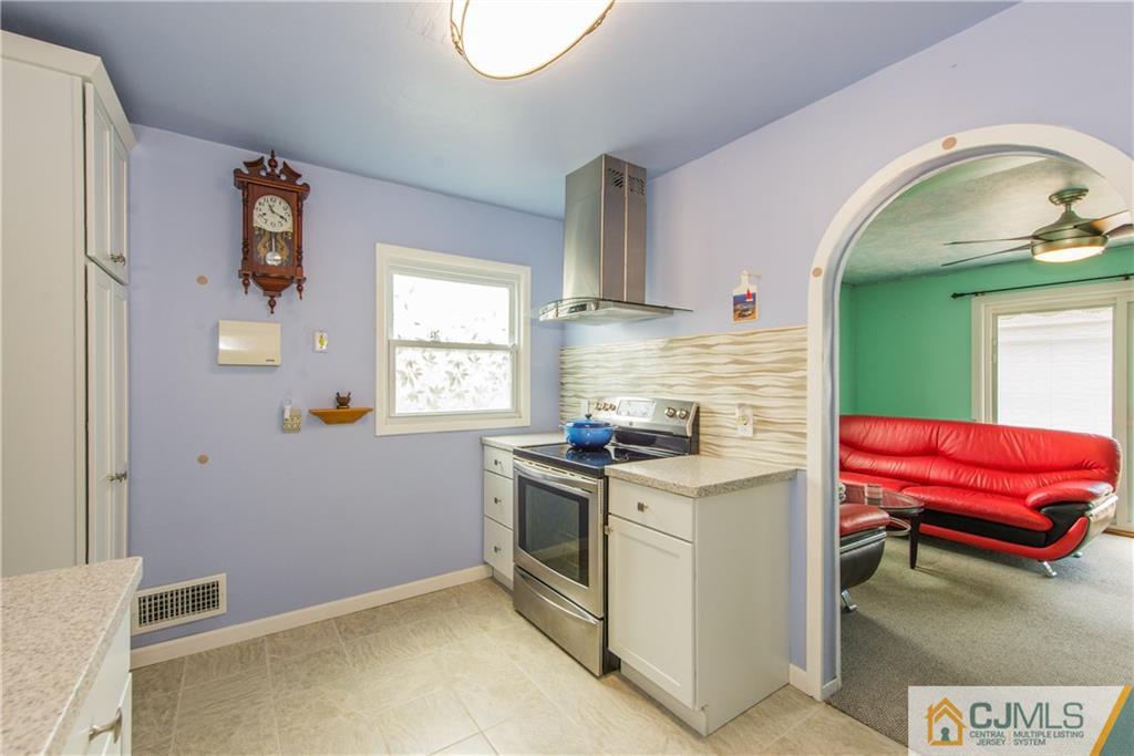 127 Idlewild Road Edison, NJ 08817 - Photo 9 of 21 a kitchen with a stove and a microwave