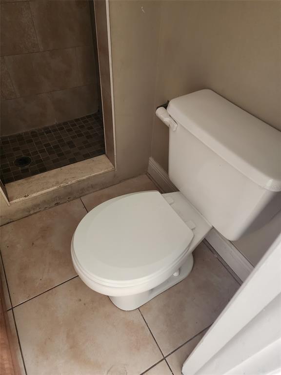 3904 West Walnut Street Tampa, FL 33607 - Photo 11 of 16 a bathroom with a toilet and a mirror