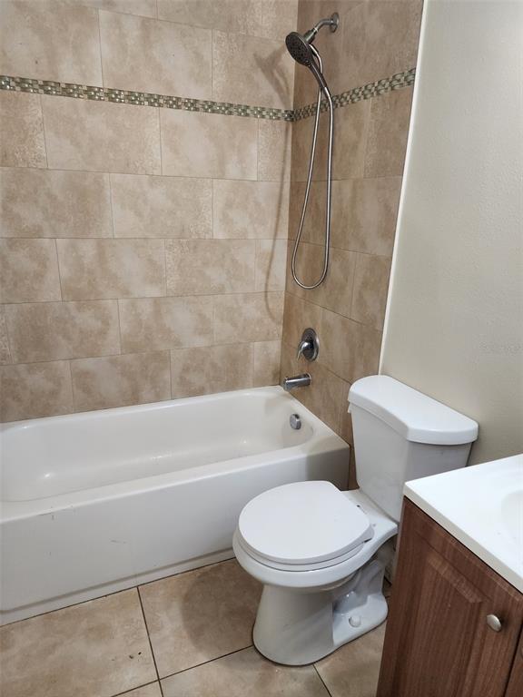 3904 West Walnut Street Tampa, FL 33607 - Photo 14 of 16 a white toilet and tub sitting next to a bathroom sink