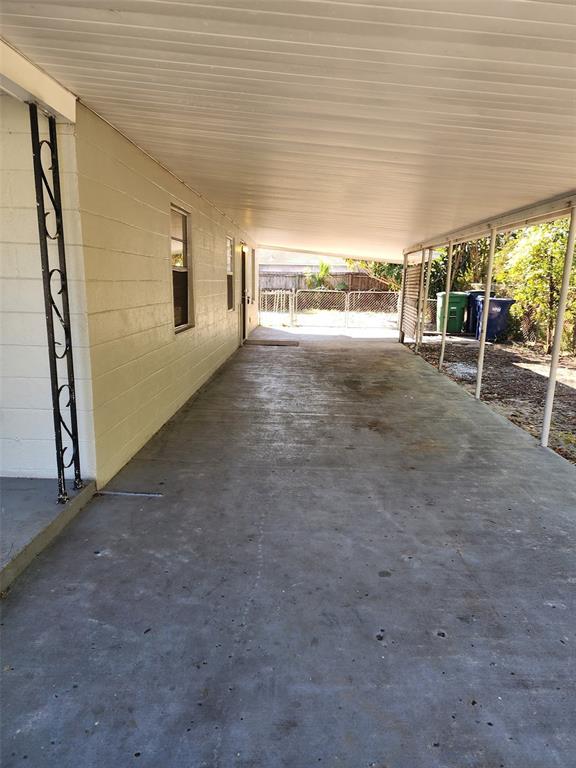 3904 West Walnut Street Tampa, FL 33607 - Photo 3 of 16 a view of a big room with wooden floor and windows