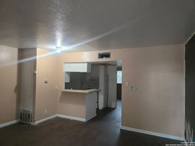 an empty room with closet and windows