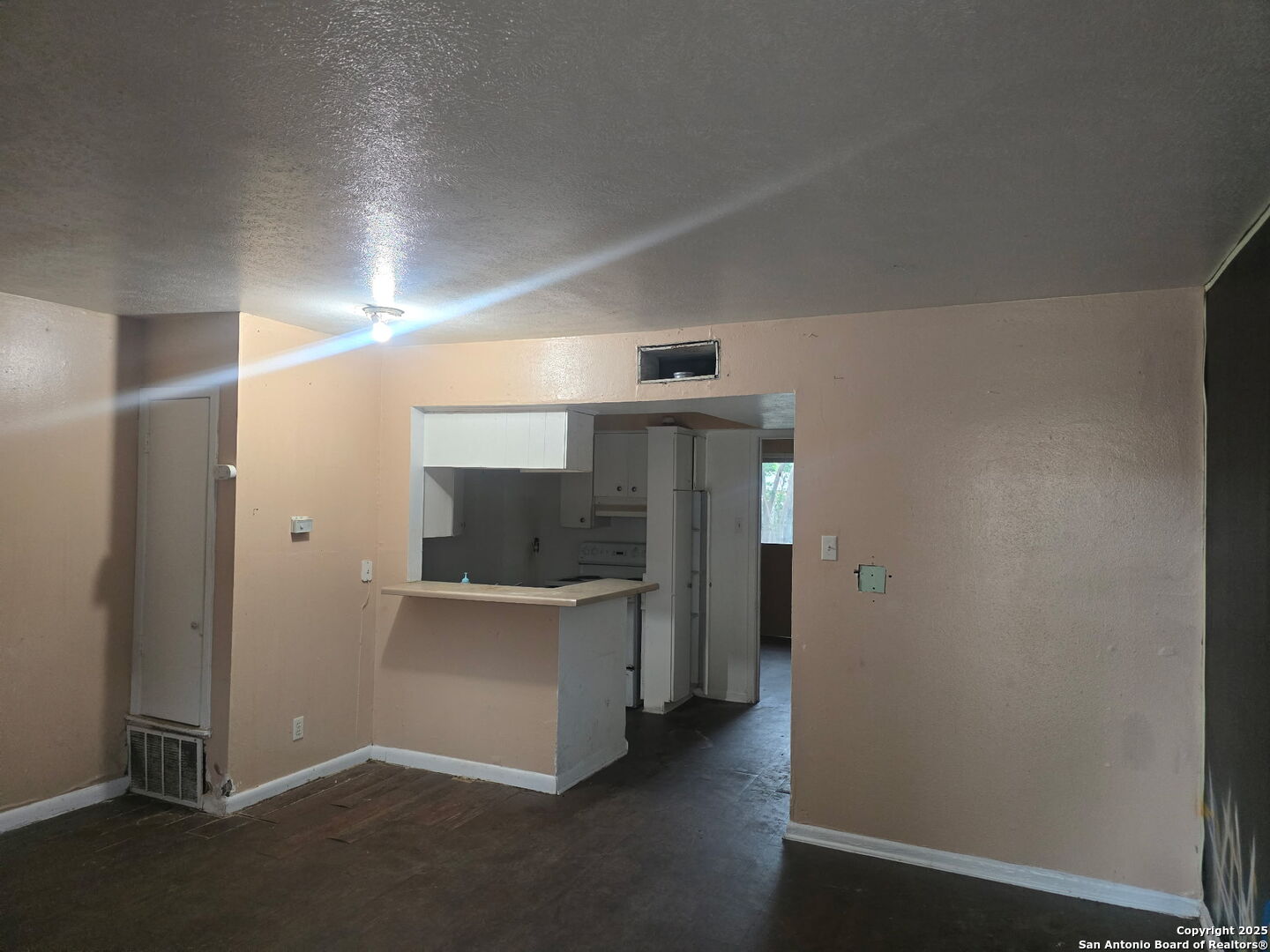 an empty room with closet and windows