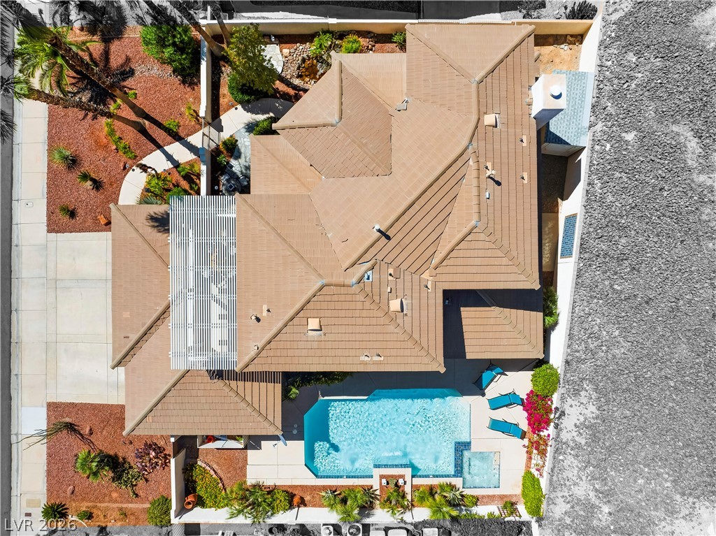 1135 Calico Ridge Drive Henderson, NV 89011 - Photo 62 of 86 An aerial perspective showcases a private pool area and lush, xeriscaped landscaping surrounding the residence.