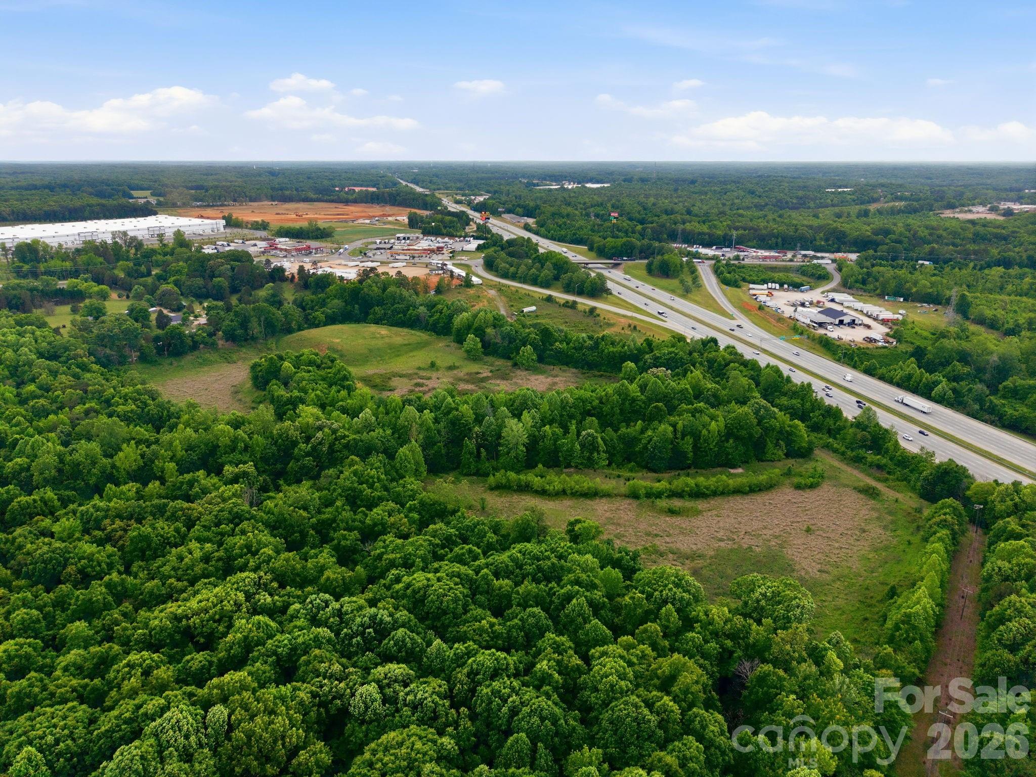 1140 Peeler Road Salisbury, NC 28146 - Photo 4 of 15 a view of a city with lush green forest