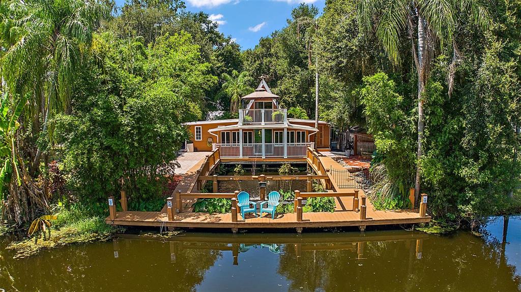 a view of a house with a large pool with a yard in front of it