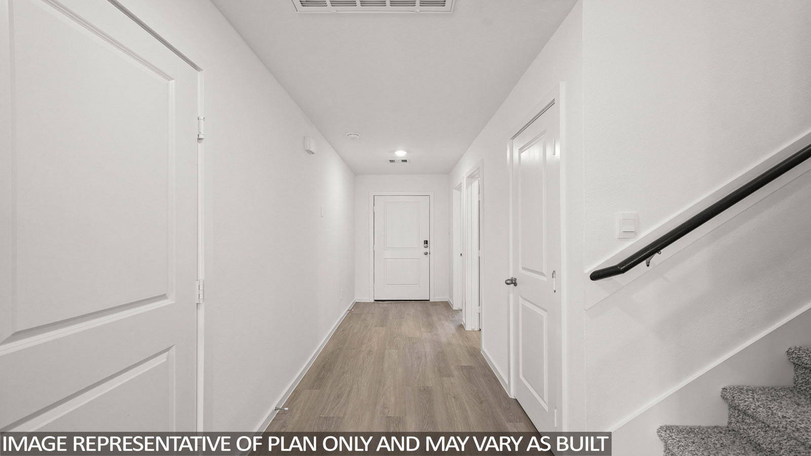 116 Baby Calf Roping Road Jarrell, TX 76537 - Photo 3 of 23 A well-lit entry hall with light wood flooring leads toward a white door.
