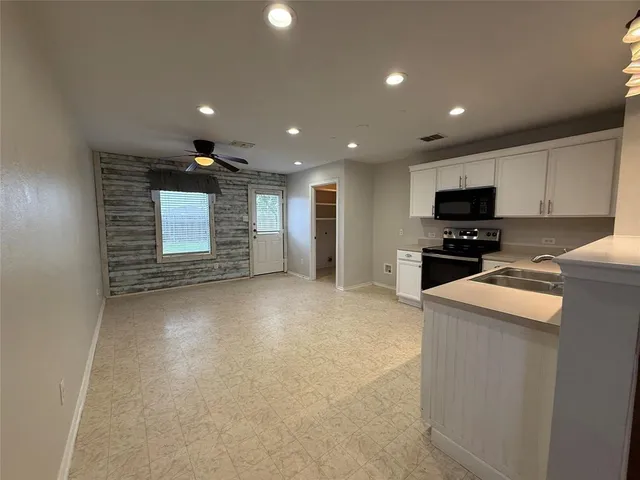 a view of kitchen with cabinets and wooden floor