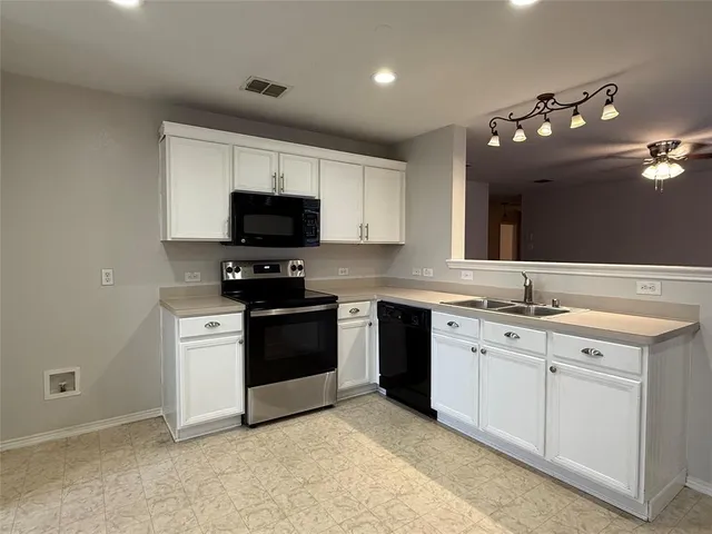a kitchen with a sink stove and microwave