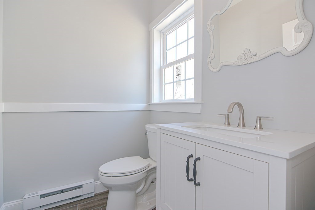 260 Main Street, Unit 3 Blackstone, MA 01504 - Photo 13 of 40 a bathroom with a sink a toilet and a window
