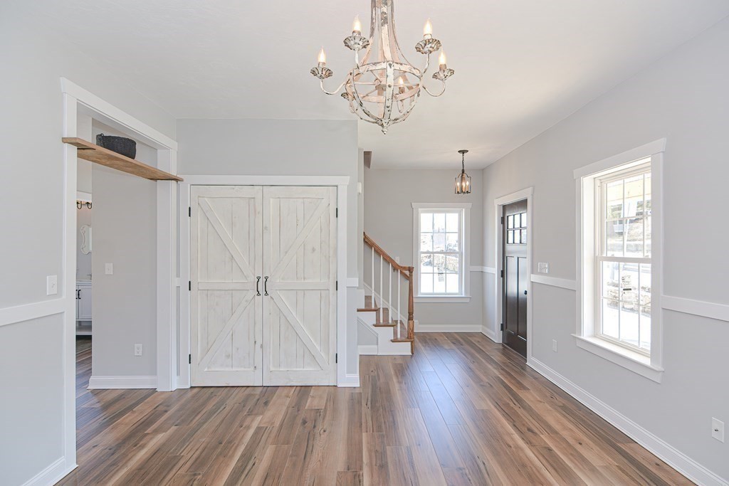 260 Main Street, Unit 3 Blackstone, MA 01504 - Photo 17 of 40 a view of an entryway with wooden floor and a window