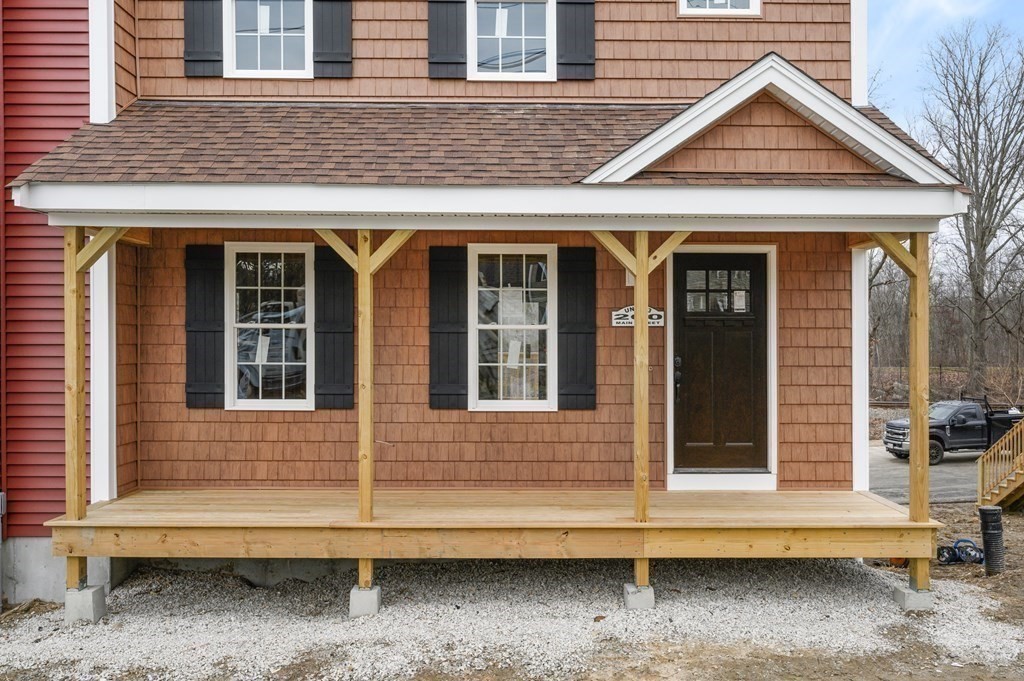260 Main Street, Unit 3 Blackstone, MA 01504 - Photo 18 of 40 a view of brick house with large windows