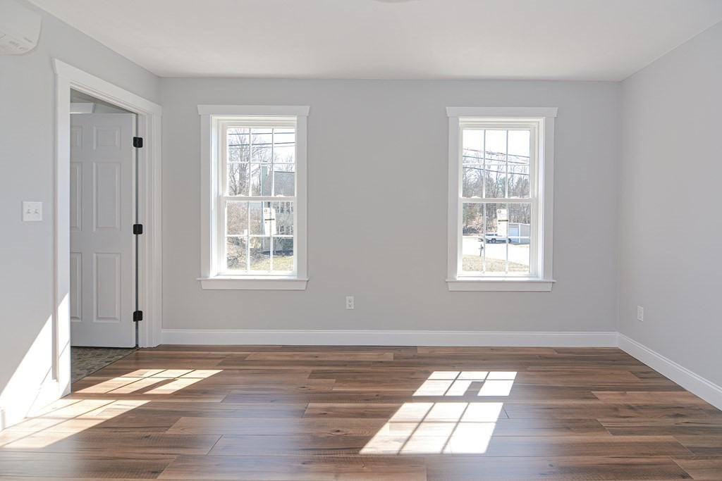 260 Main Street, Unit 3 Blackstone, MA 01504 - Photo 25 of 40 a view of an empty room with wooden floor and a window