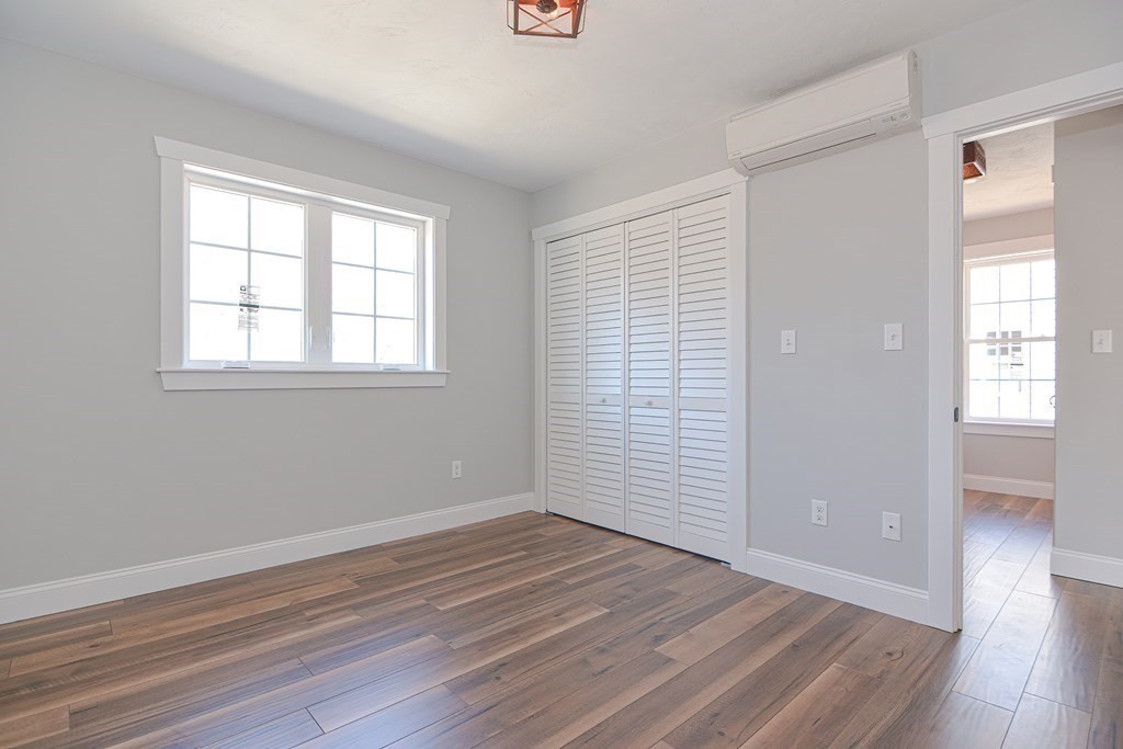 260 Main Street, Unit 3 Blackstone, MA 01504 - Photo 26 of 40 an empty room with wooden floor and windows