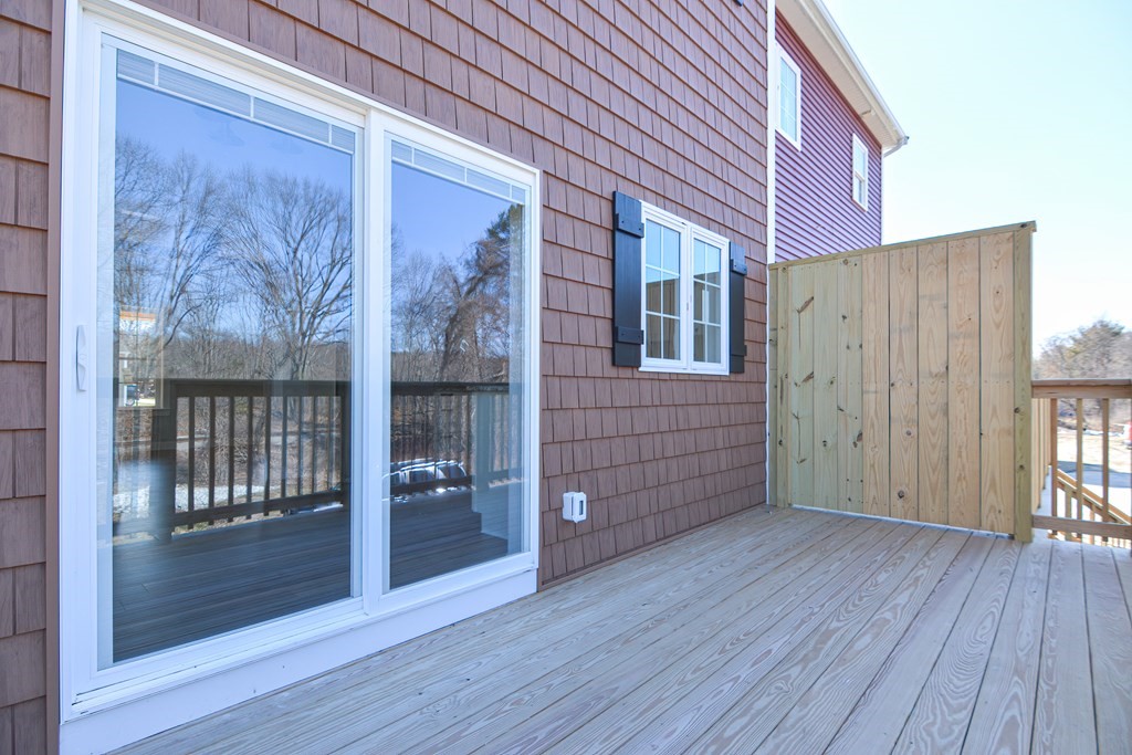 260 Main Street, Unit 3 Blackstone, MA 01504 - Photo 39 of 40 a view of a backyard with wooden floor and brick wall