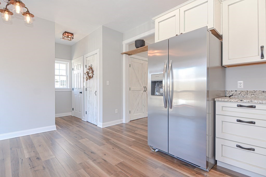 260 Main Street, Unit 3 Blackstone, MA 01504 - Photo 6 of 40 a kitchen with stainless steel appliances a refrigerator and a wooden floor
