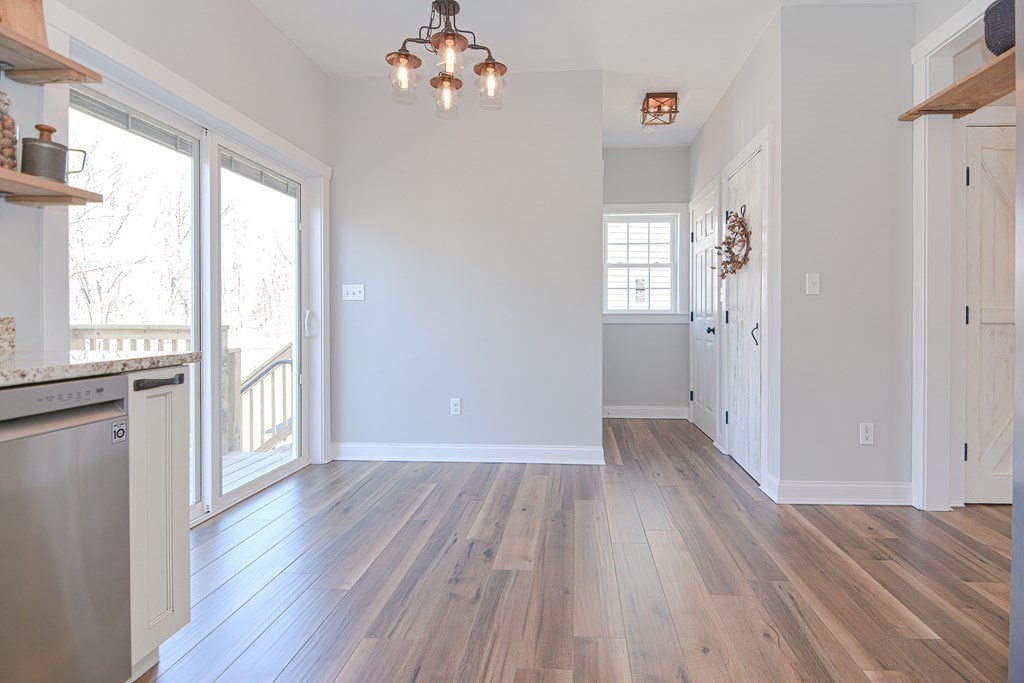 260 Main Street, Unit 3 Blackstone, MA 01504 - Photo 8 of 40 a view of an empty room with wooden floor and a window