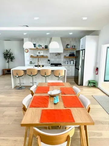 a view of a dining room with furniture and wooden floor