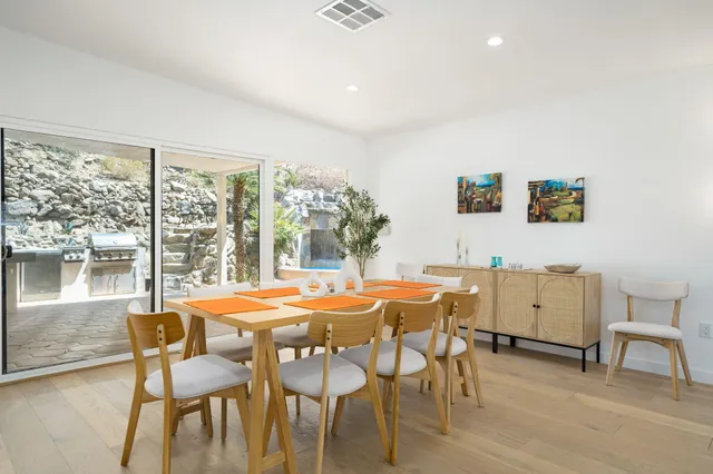 a bedroom with a large bed and a flat tv screen on dresser